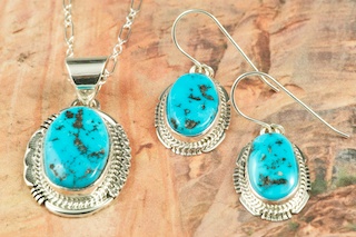 Genuine Sleeping Beauty Turquoise set in Sterling Silver. Beautiful Pendant and Earrings Set. The Sleeping Beauty Mine is located in Gila County, Arizona. The photo is of the jewelry you will be receiving. Created by Navajo Artist John Nelson. Signed by the artist.